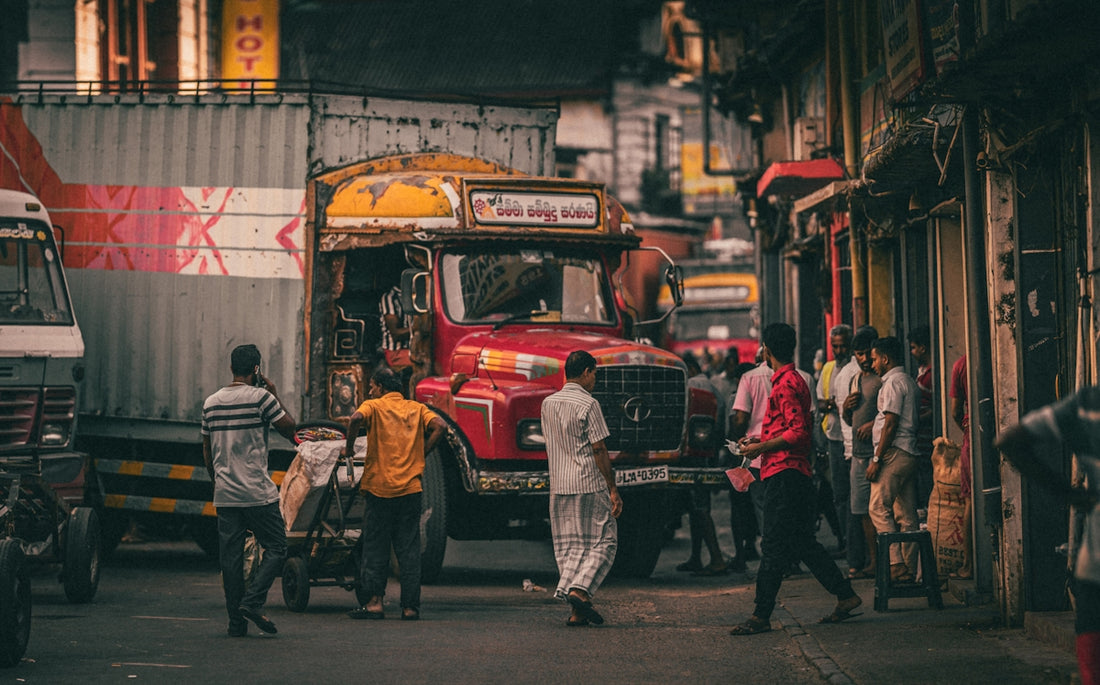 a group of people standing around a truck