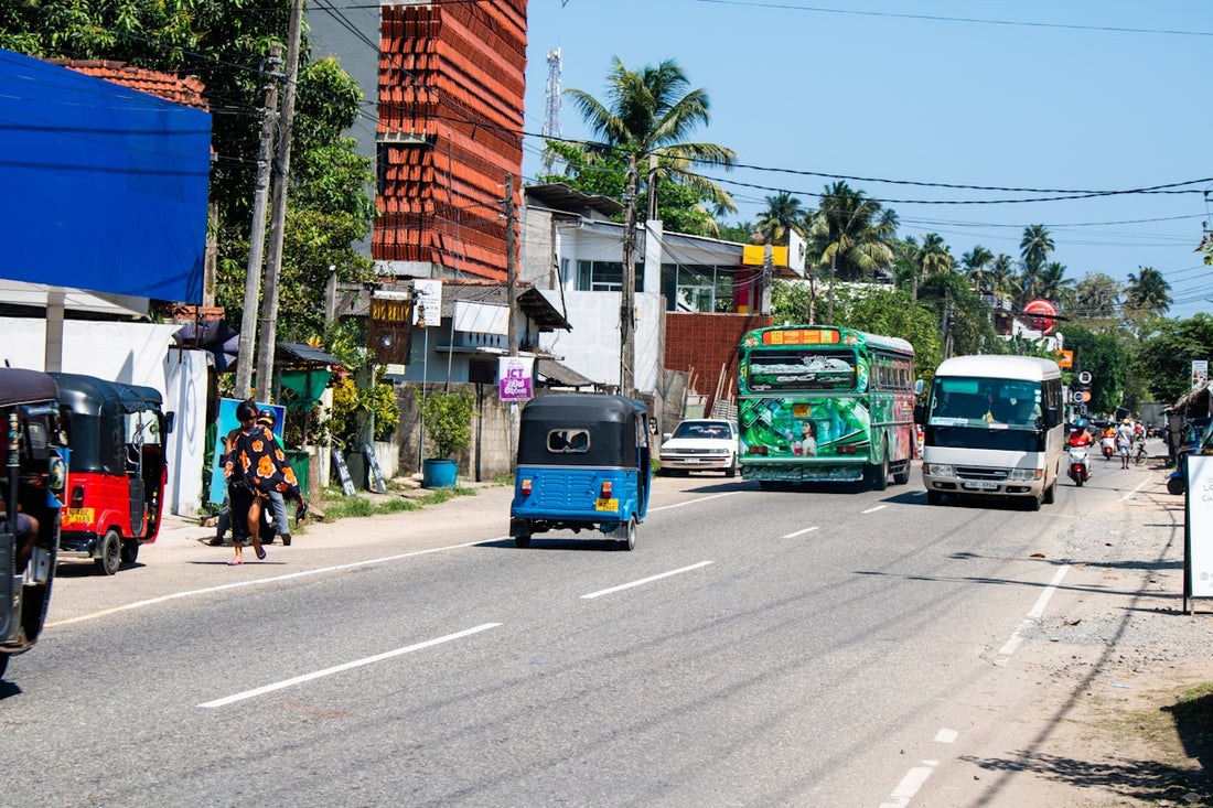 Street traffic and buildings on a sunny day.