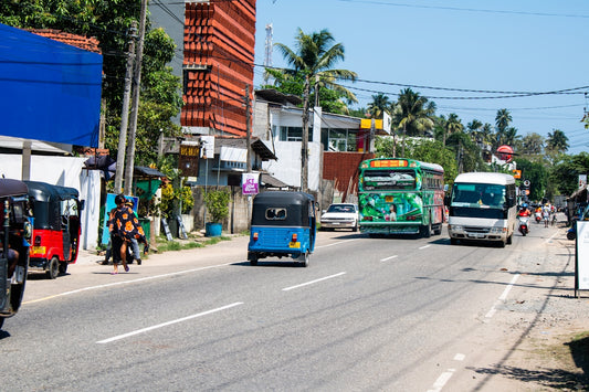 Street traffic and buildings on a sunny day.