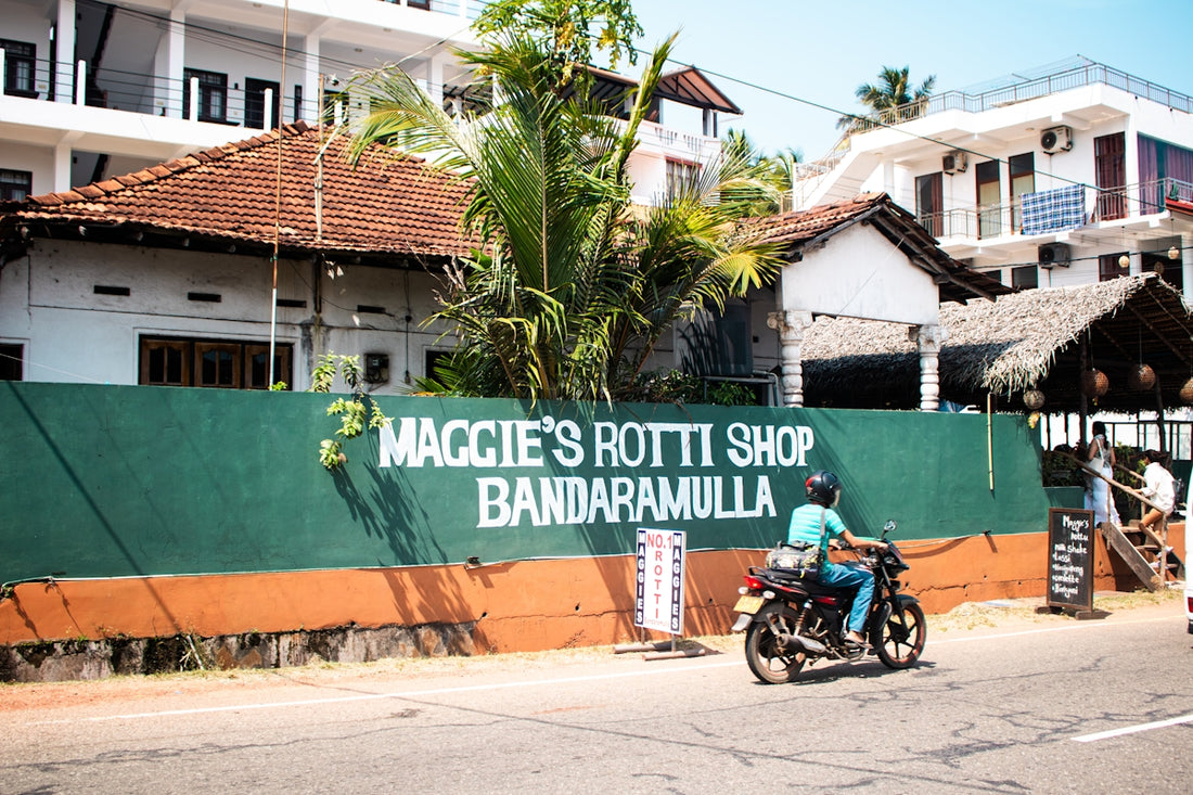 Maggie's rotti shop with a motorcycle passing by.