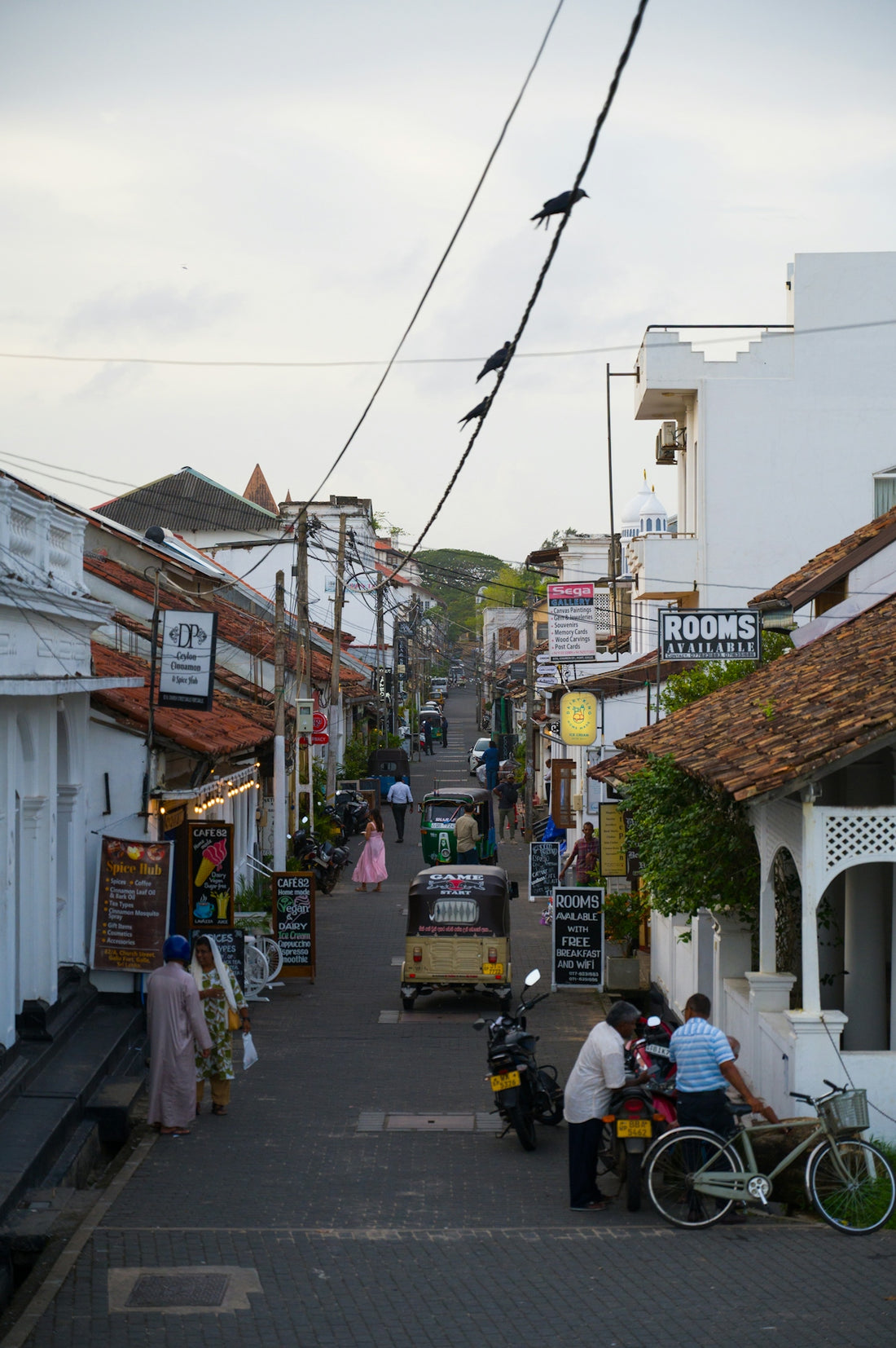 A narrow street in a busy, coastal town.